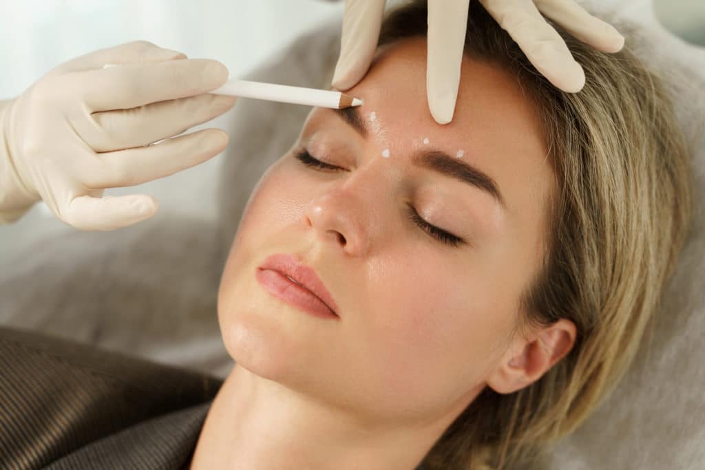 A Woman getting treatment on Face | Dermal Fillers | Skynn MD in Holly Springs, NC