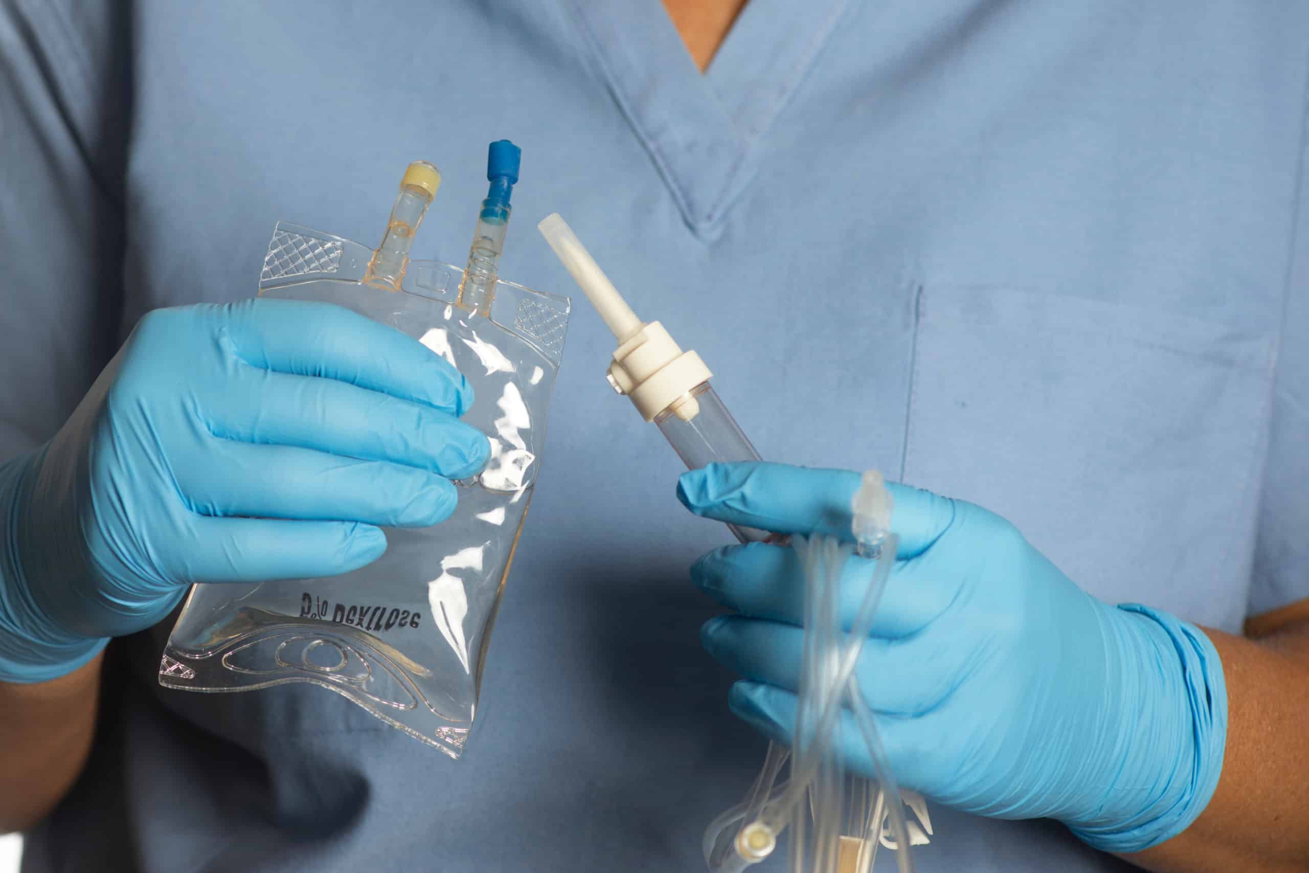 Nurse holds 5% dextrose solution and IV infusion tubing | Skynn MD in Holly Springs, NC