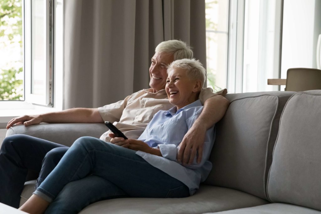 Happy Couple Sitting in Sofa | Skynn MD in Holly Springs, NC