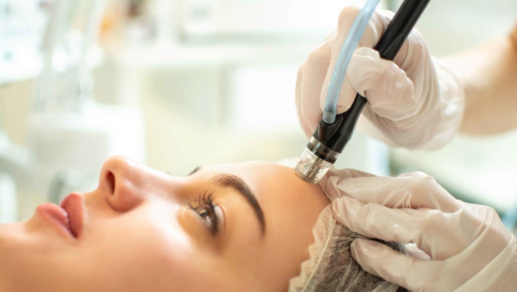 A Woman getting HydraFacial treatment | Skynn MD in Holly Springs, NC