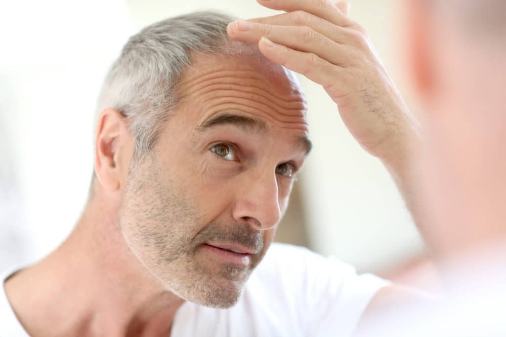 Old Man Checking his Hair on Mirror | Skynn MD in Holly Springs, NC