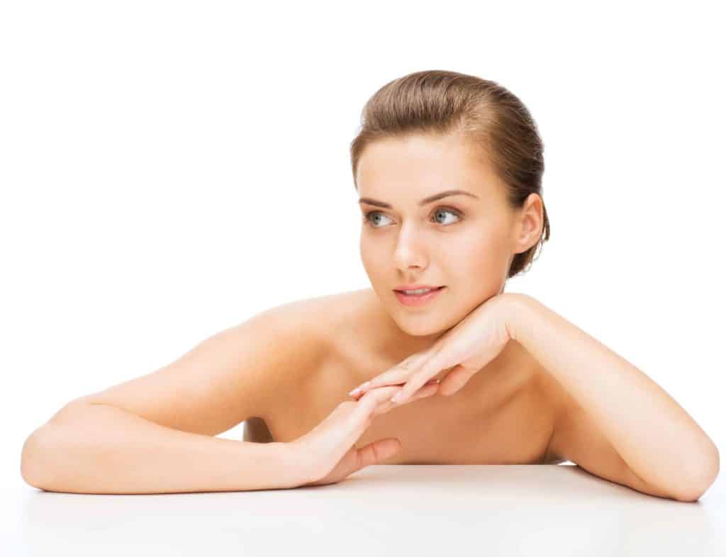 Young Attractive Woman Holding Hands Under her Chin | Skynn MD in Holly Springs, NC
