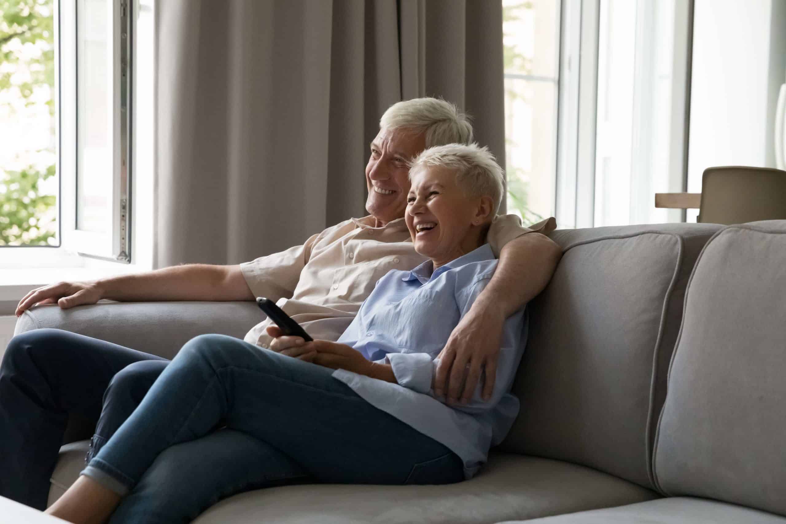 Happy Couple Sitting in Sofa | Skynn MD in Holly Springs, NC