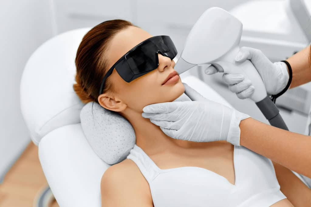 Laser hair removal treatment. Doctor holding. Clinic skin care procedure. Medical dermatology photo equipment. People epilation device. Cosmetology technology salon epilation. Body aesthetic | SKYNN MD in Holly Springs, NC