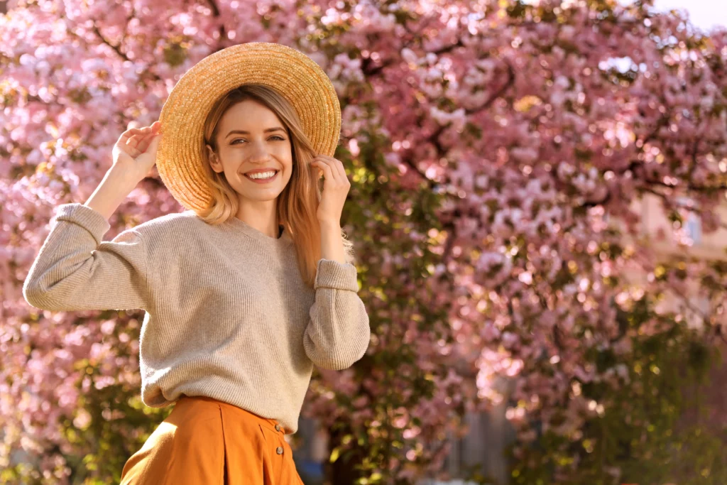 a woman wearing a hat and smiling