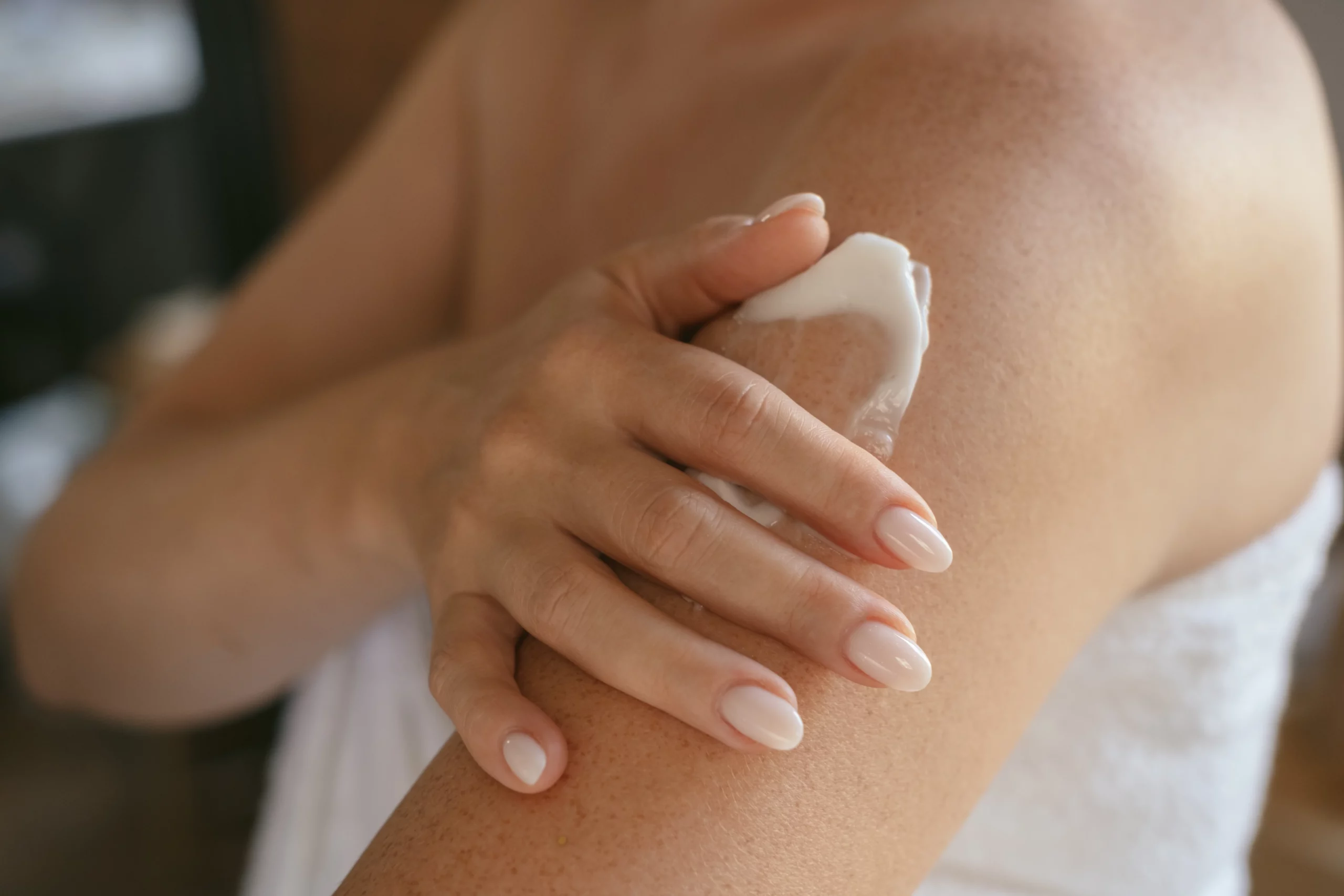 A person applying cream on their arm, promotes new skin cell growth for a refreshed look in Holly Springs, NC