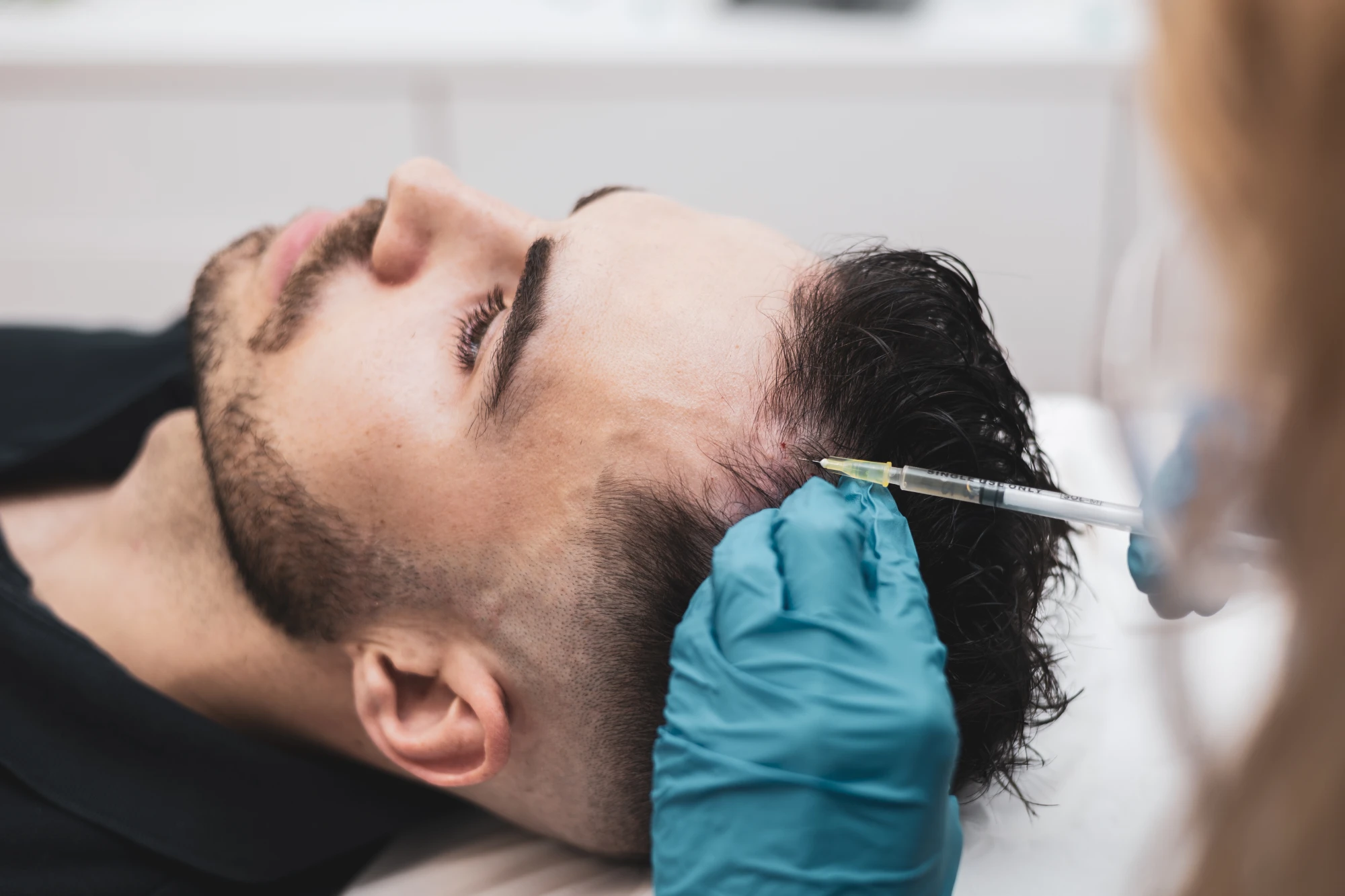 a man getting hair injection prp in Holly Springs, NC